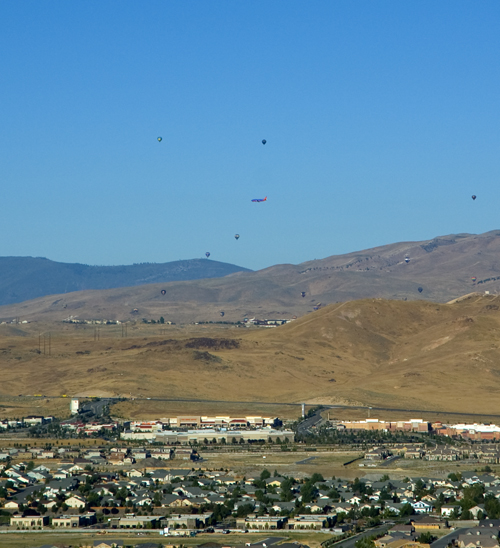 Plane flying close to the hot air balloons in Reno