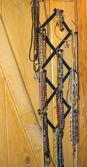 necklaces hanging on a rack inside my closet door