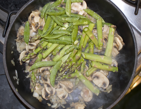 snap peas and asparagus pieces added to pan